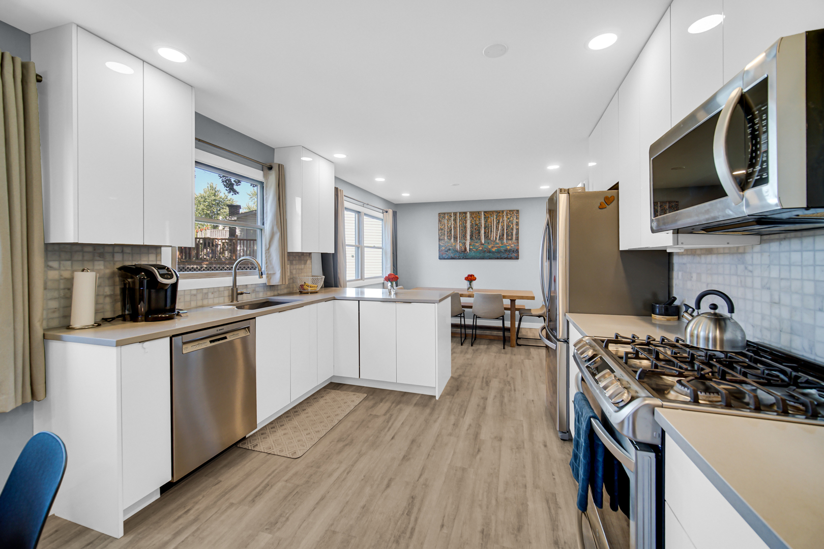 1028 West Park Pl Drive Bartlett, IL 60103 - Photo 7 of 24 a kitchen with a stove a sink and a microwave