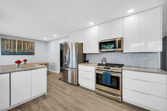 a kitchen with a stove and a refrigerator
