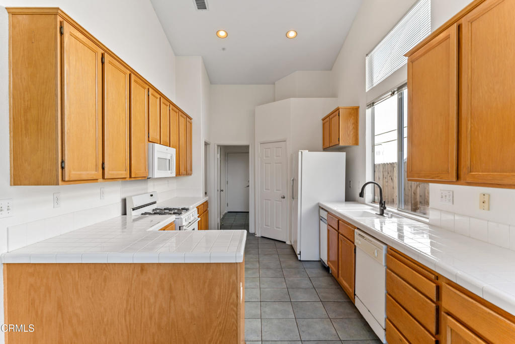 408 Grande Street Oxnard, CA 93036 - Photo 16 of 45 a bathroom with a granite countertop sink and a large mirror