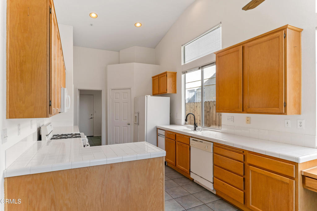 408 Grande Street Oxnard, CA 93036 - Photo 17 of 45 a kitchen with a sink a stove and cabinets