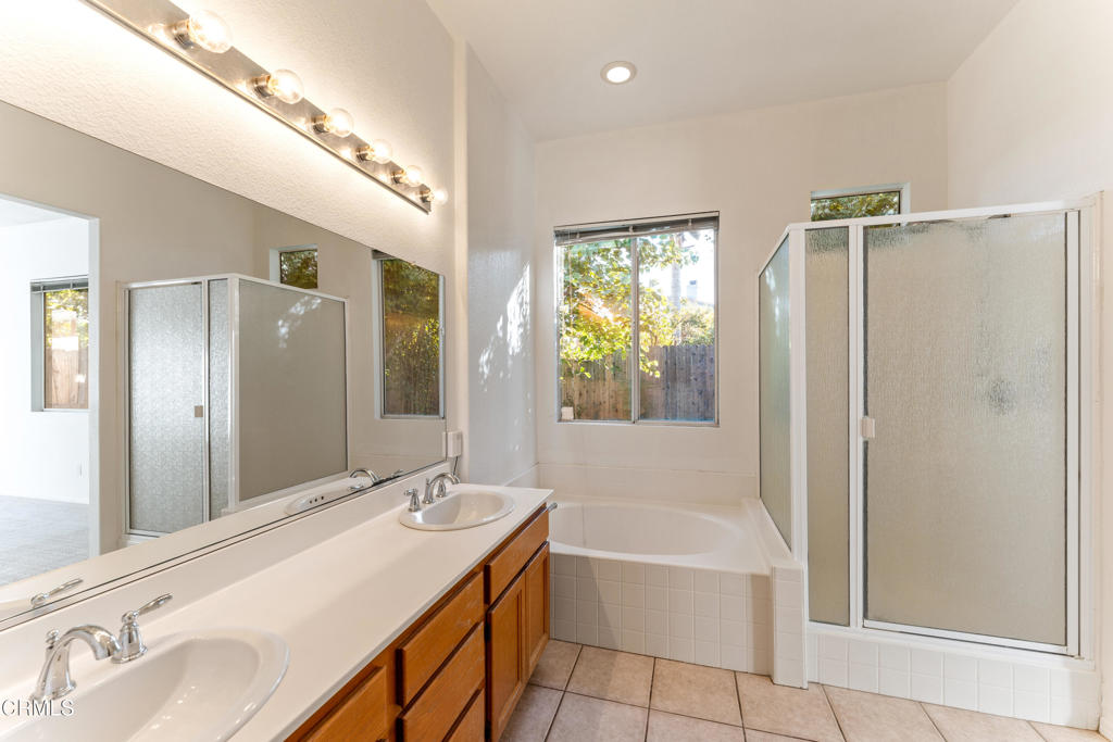408 Grande Street Oxnard, CA 93036 - Photo 25 of 45 a bathroom with a tub sink and mirror