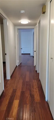 a view of hallway with wooden floor