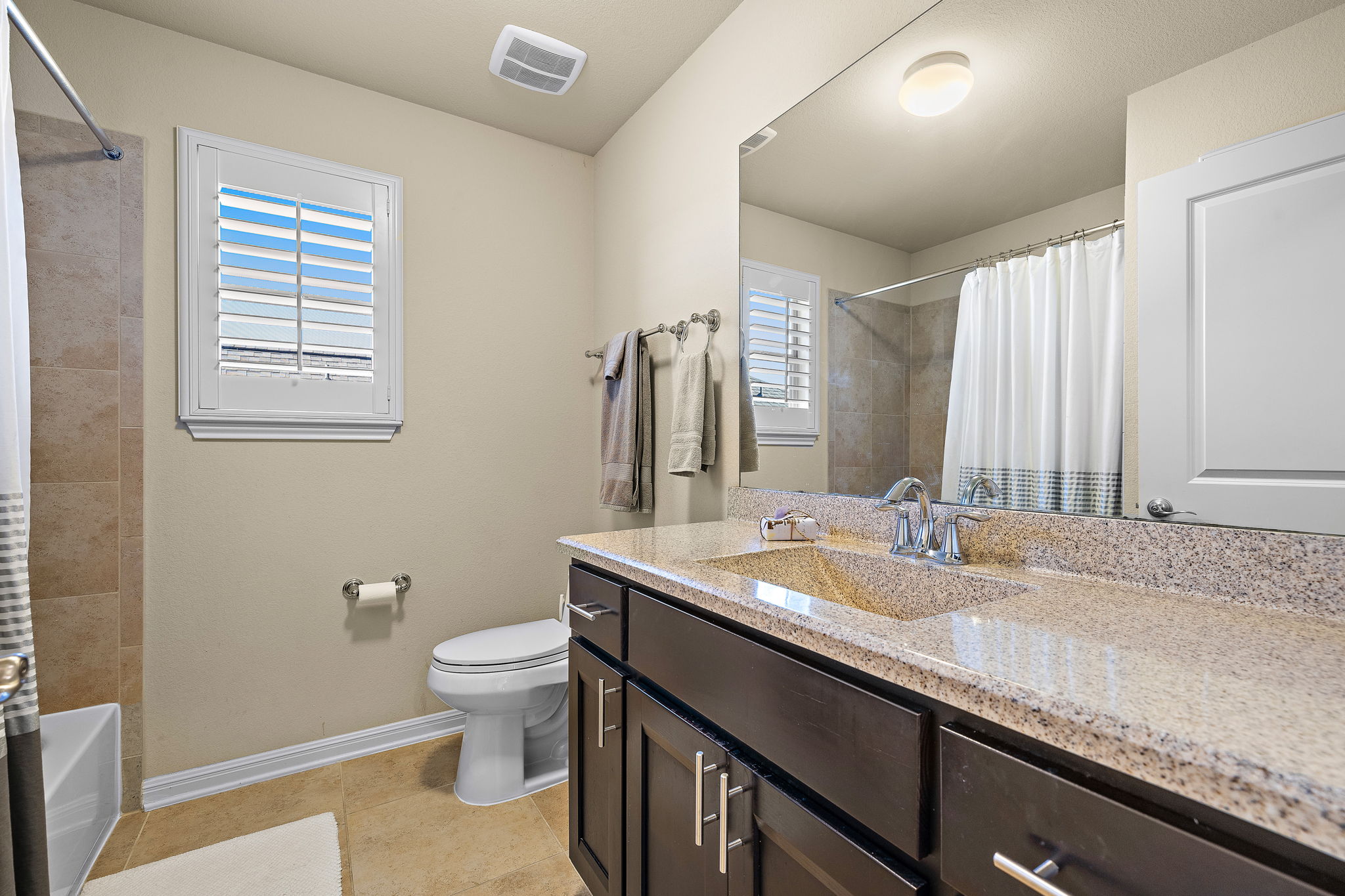 4413 Tambre Bend Austin, TX 78738 - Photo 26 of 30 Full bathroom with vanity, light tile patterned floors, and shower / bath combo with shower curtain