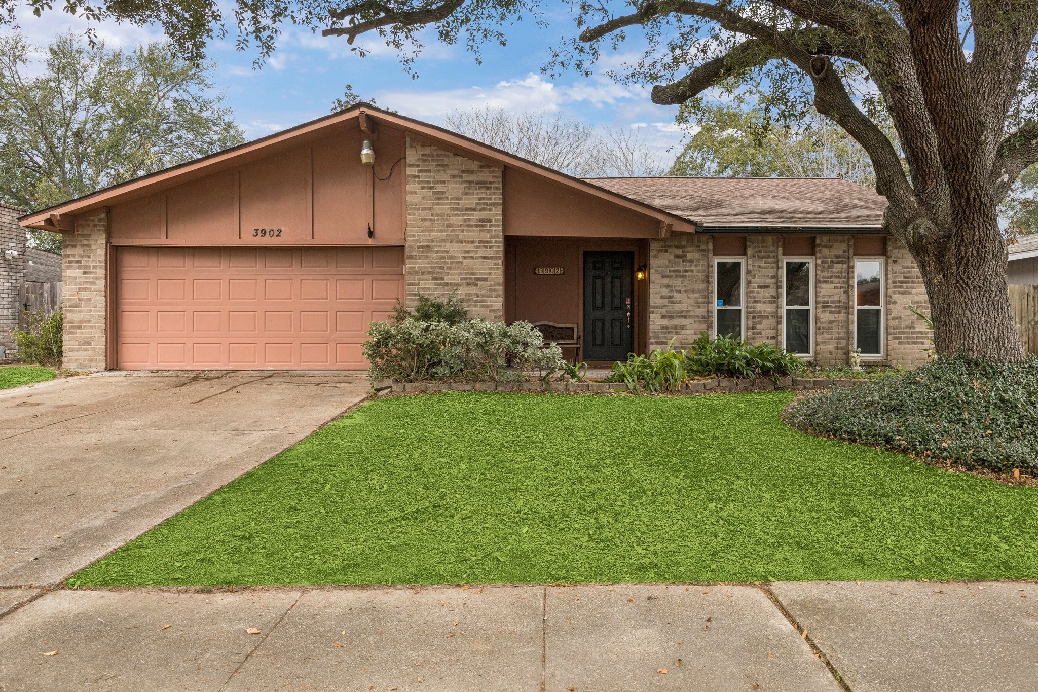 a front view of a house with a garden and plants