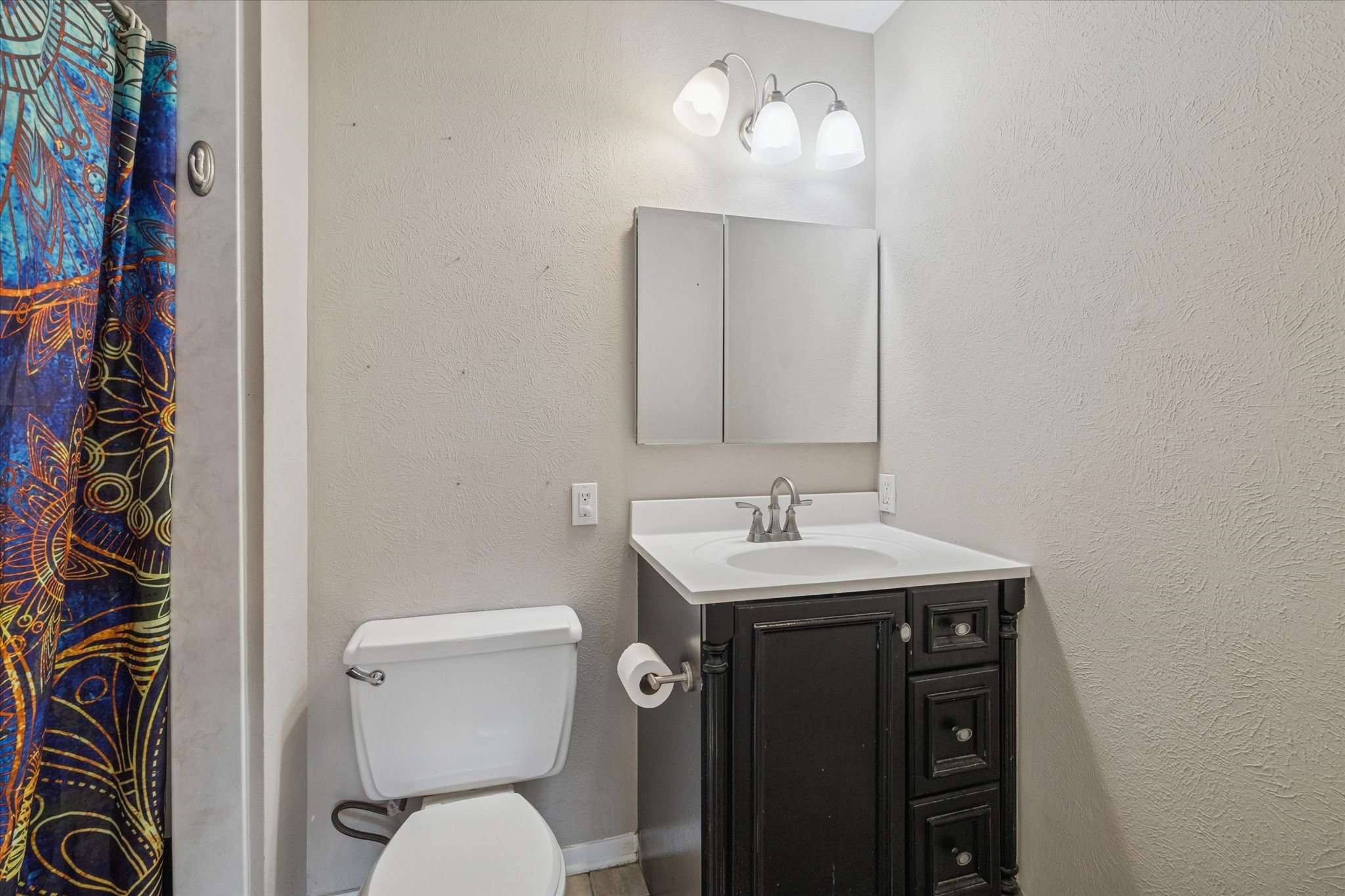 3902 Broken Elm Drive Spring, TX 77388 - Photo 10 of 19 a bathroom with a toilet a sink and mirror