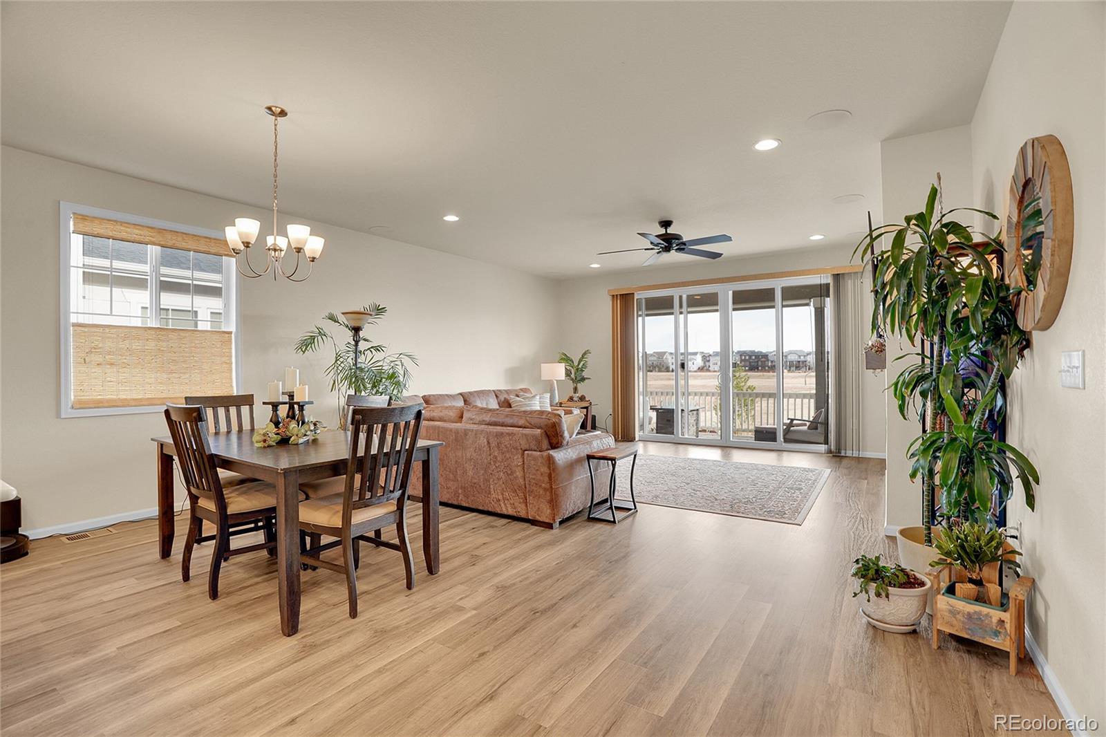 815 Bear Peak Road Erie, CO 80516 - Photo 11 of 32 a dining room with furniture potted plants and wooden floor