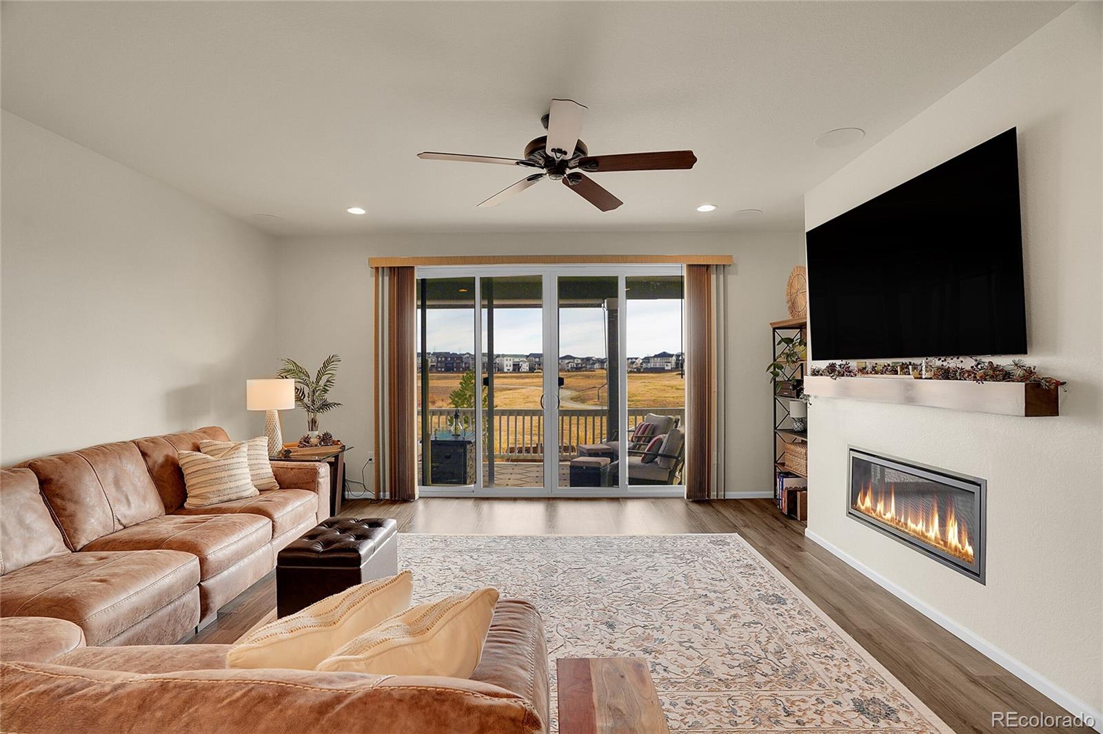815 Bear Peak Road Erie, CO 80516 - Photo 13 of 32 a living room with furniture and a flat screen tv