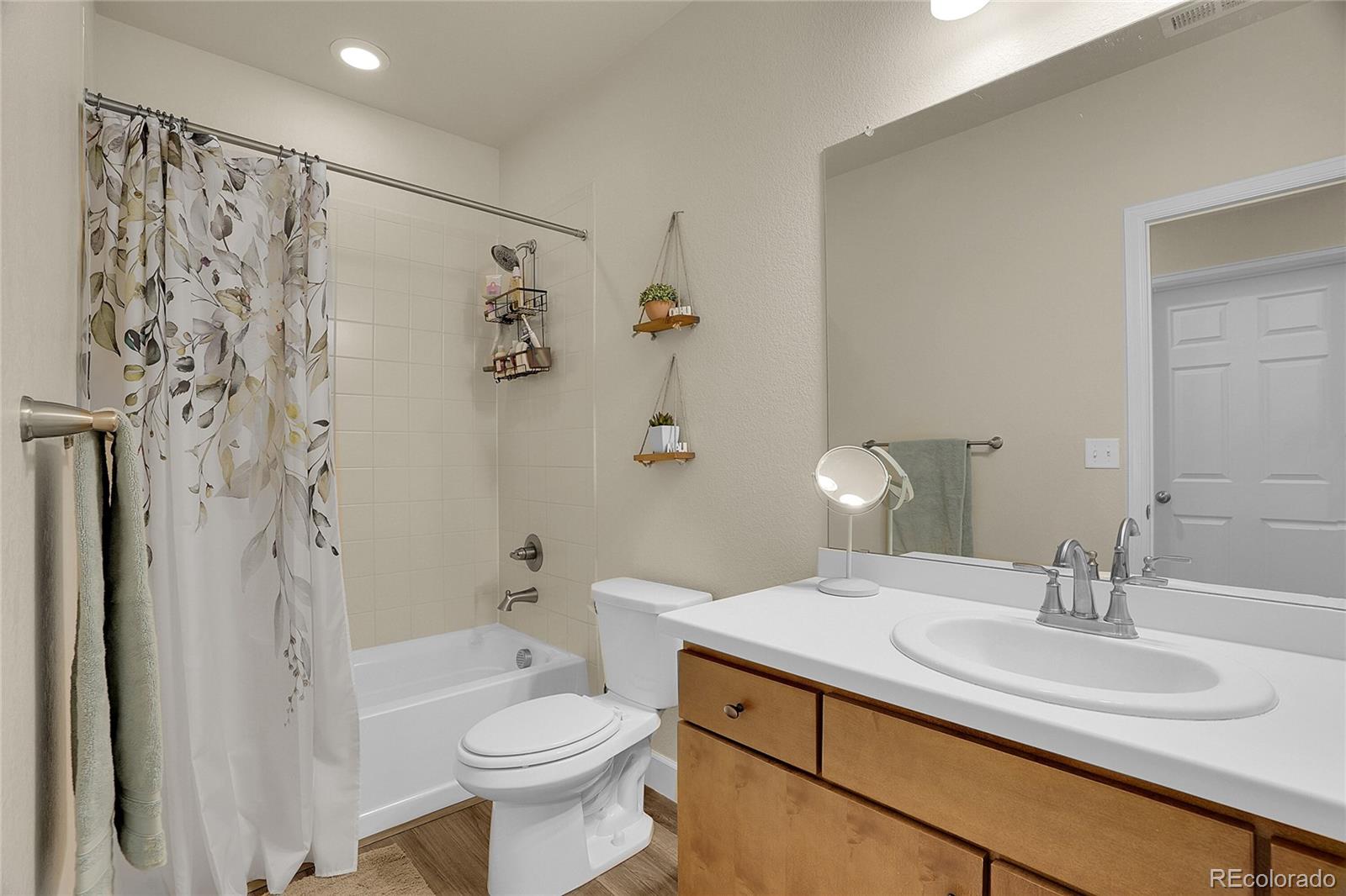 815 Bear Peak Road Erie, CO 80516 - Photo 25 of 32 a bathroom with a sink toilet and shower