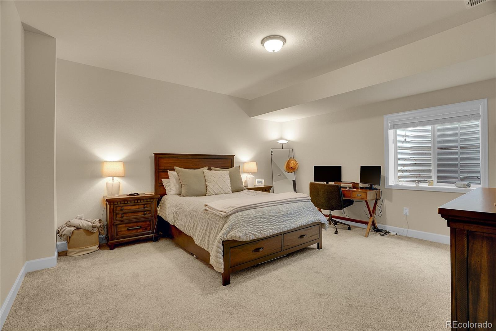 815 Bear Peak Road Erie, CO 80516 - Photo 26 of 32 a spacious bedroom with a bed and a desk