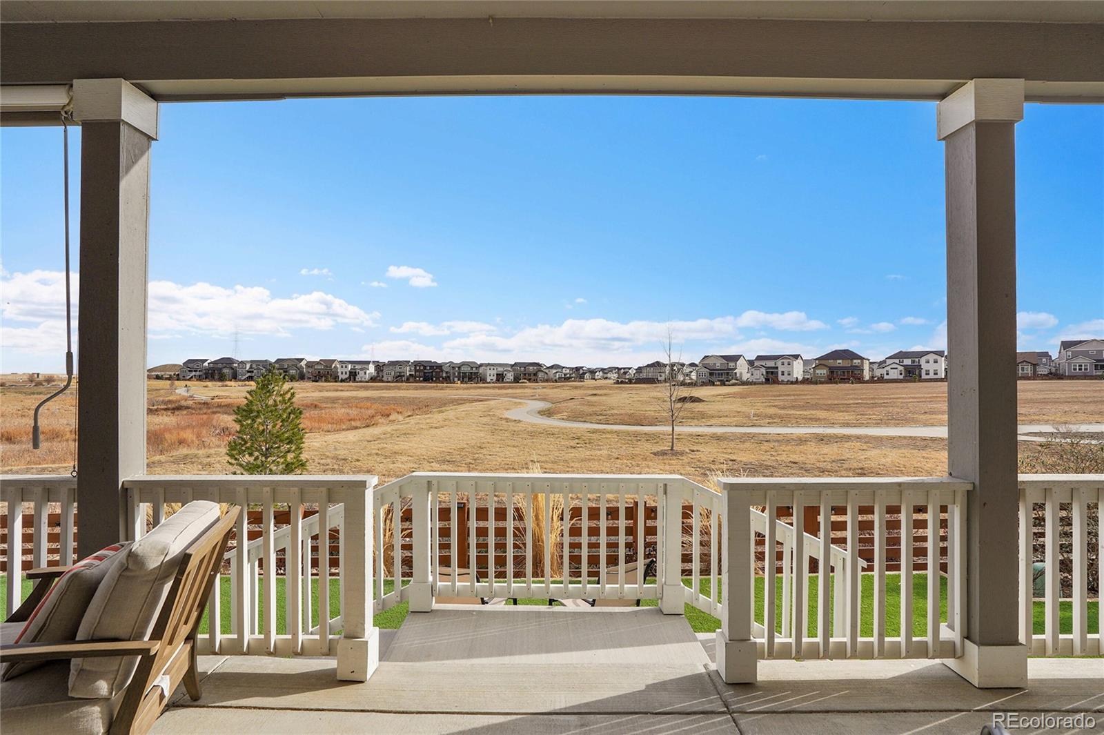 815 Bear Peak Road Erie, CO 80516 - Photo 27 of 32 a view of a balcony with wooden floor & fence