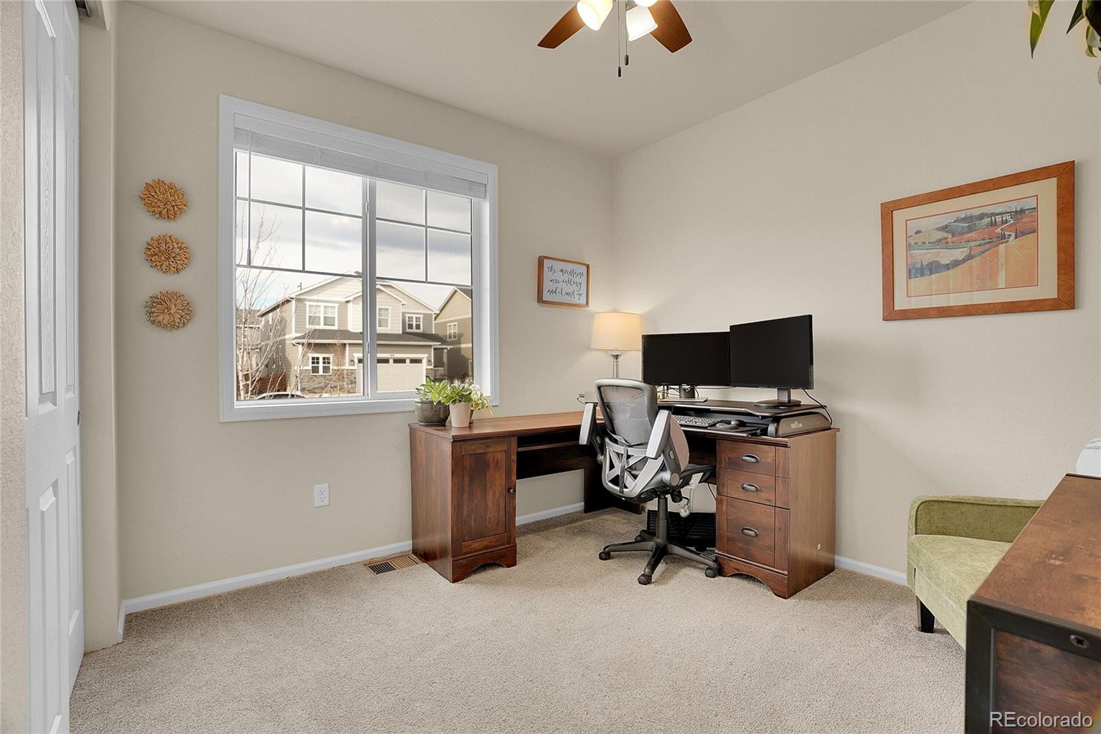 815 Bear Peak Road Erie, CO 80516 - Photo 3 of 32 a view of a workspace with furniture and a window