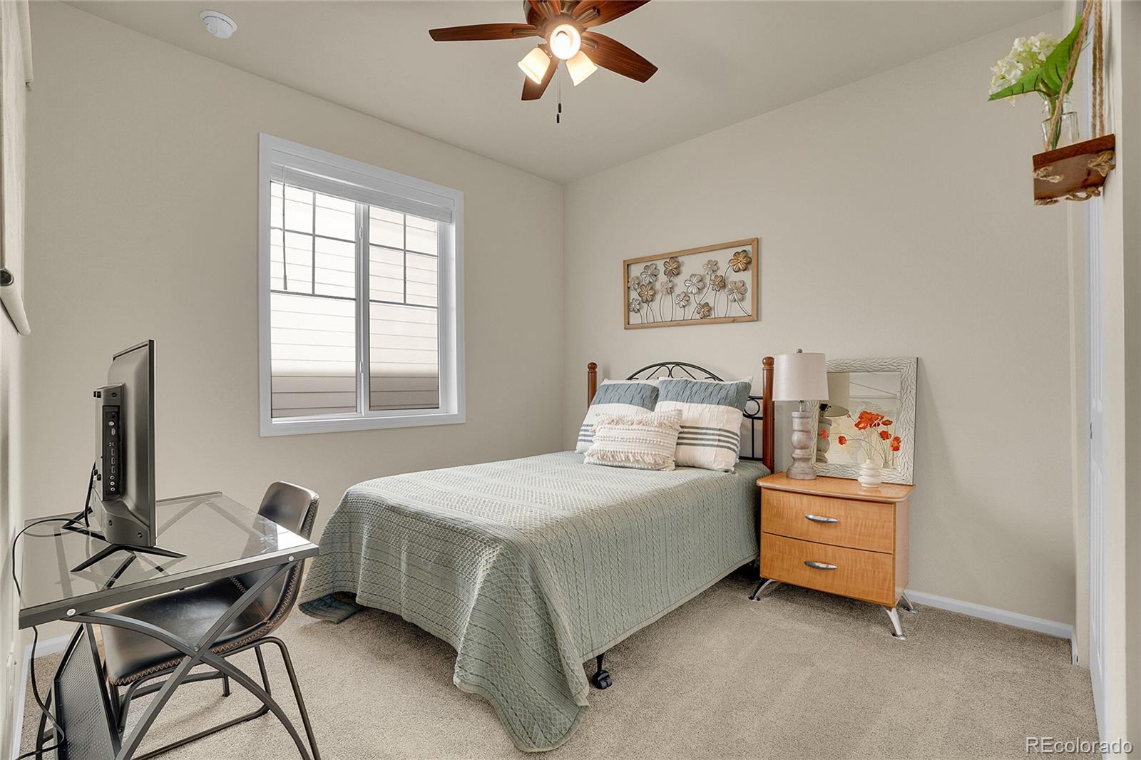 815 Bear Peak Road Erie, CO 80516 - Photo 4 of 32 a bedroom with a bed and a window