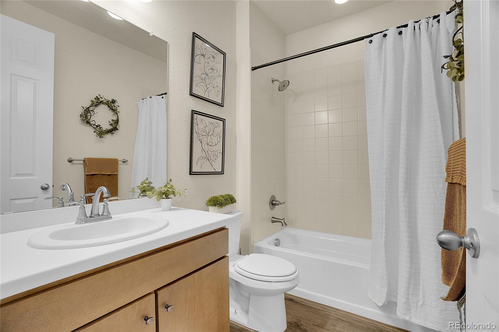 815 Bear Peak Road Erie, CO 80516 - Photo 5 of 32 a bathroom with a sink vanity mirror and toilet