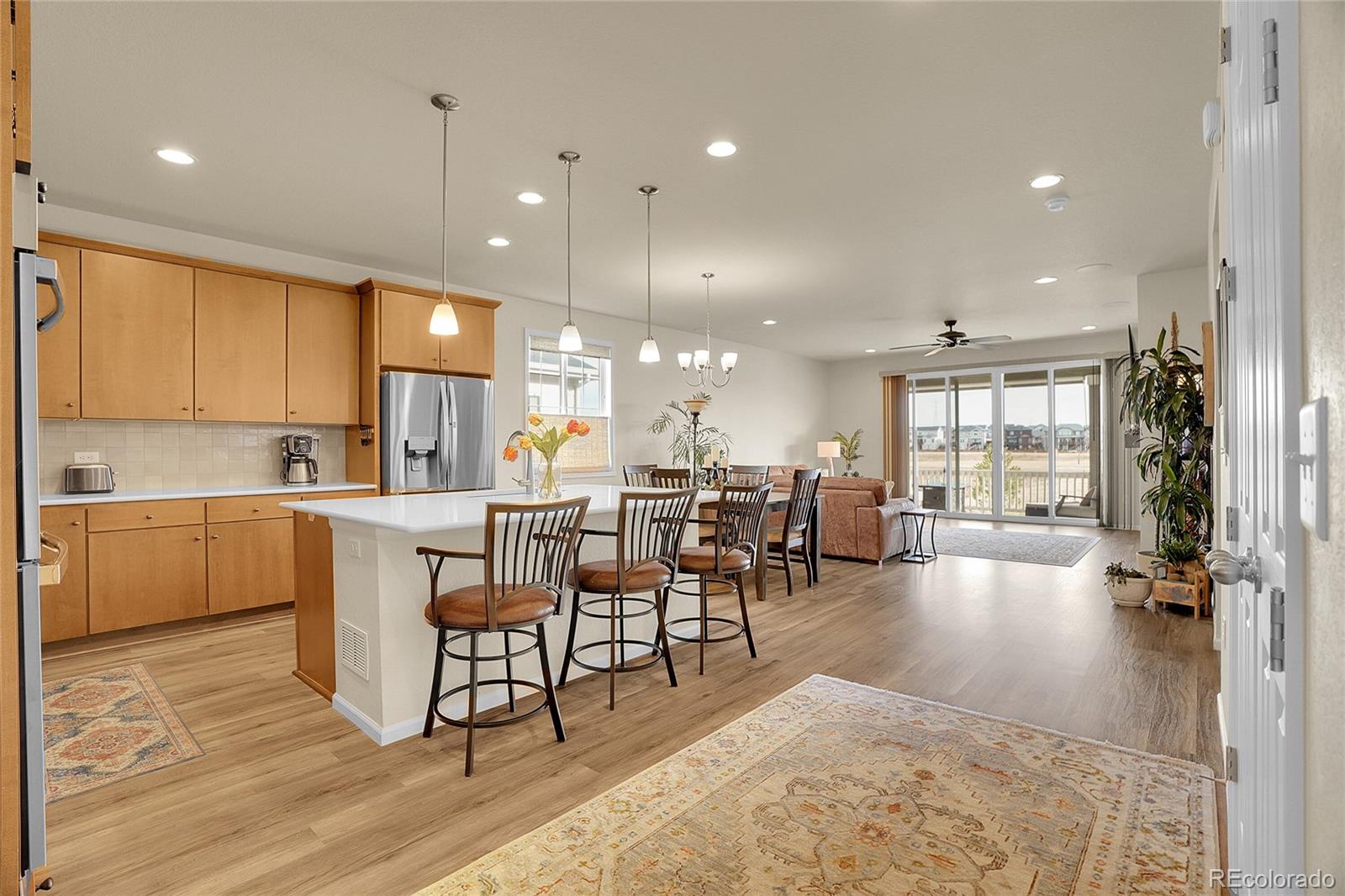815 Bear Peak Road Erie, CO 80516 - Photo 6 of 32 a large kitchen with a table and chairs