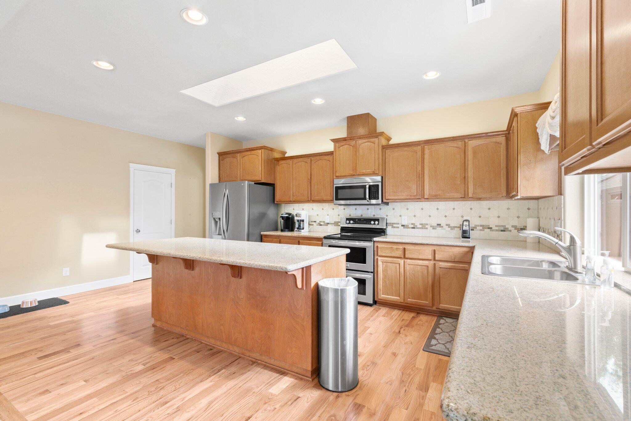 2165 Rabun Way Central Point, OR 97502 - Photo 11 of 28 a kitchen with stainless steel appliances kitchen island granite countertop a sink stove and refrigerator