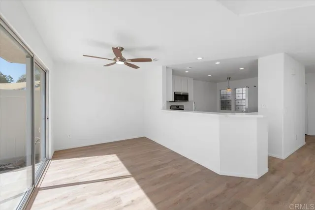 a view of an empty room with kitchen appliances