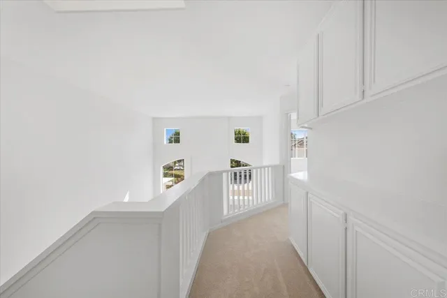 a view of a hallway with stairs