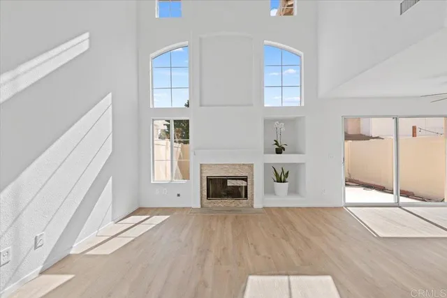 a view of a livingroom with wooden floor and fireplace