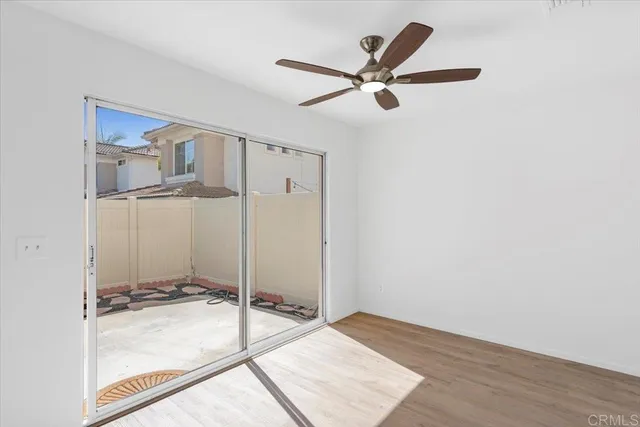 a view of a big room with wooden floor and windows