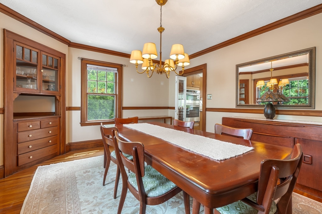 12 Grandview Road Arlington, MA 02476 - Photo 12 of 42 a dining room with a wooden table and chairs