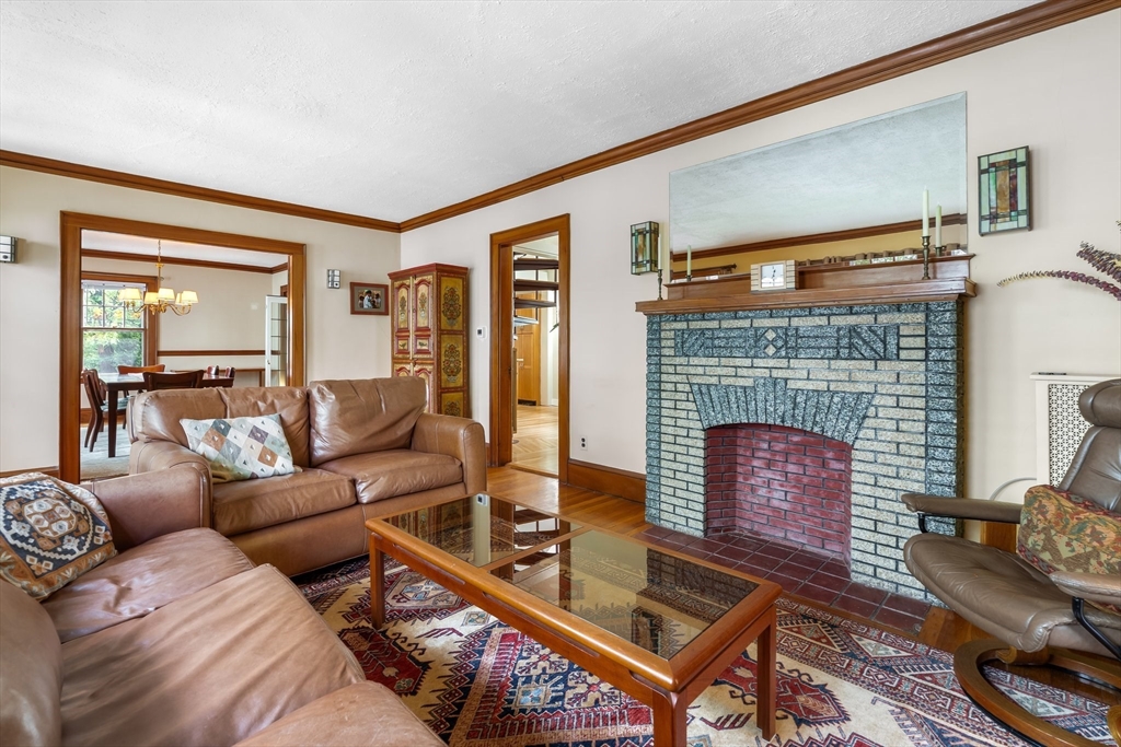 12 Grandview Road Arlington, MA 02476 - Photo 17 of 42 a living room with furniture a table and a fireplace
