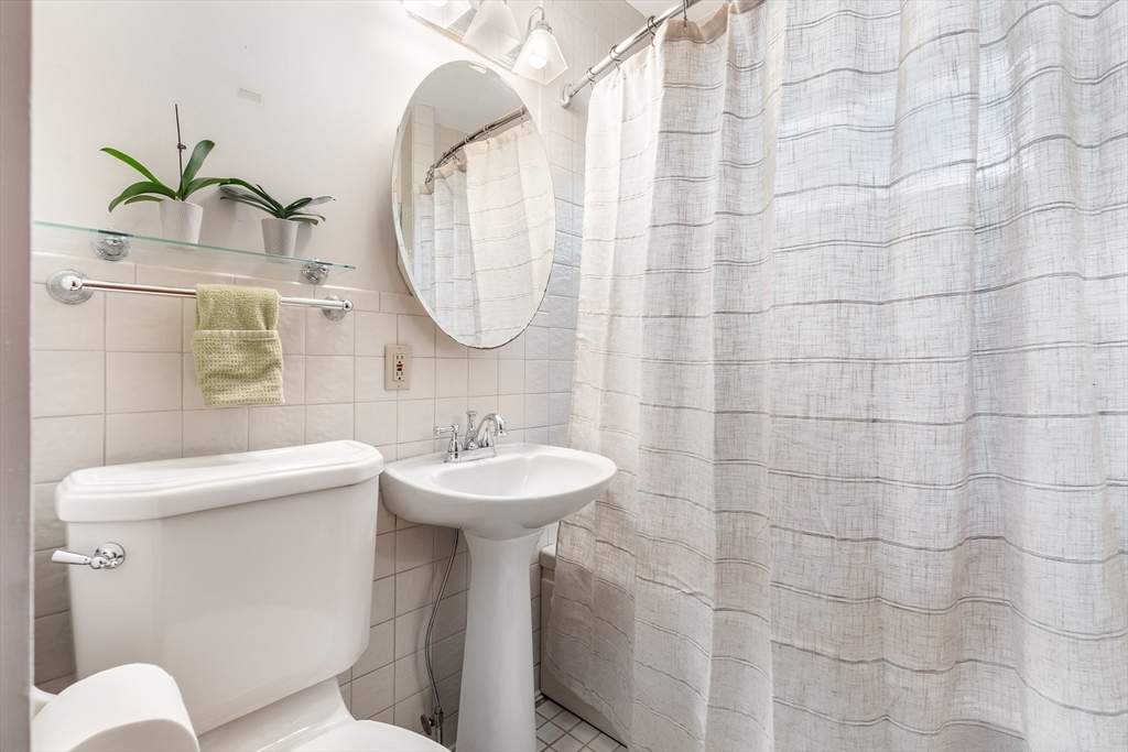 12 Grandview Road Arlington, MA 02476 - Photo 23 of 42 a bathroom with a sink a mirror a toilet and a mirror