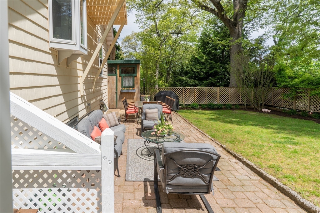 12 Grandview Road Arlington, MA 02476 - Photo 37 of 42 a view of a chair and tables in the balcony next to a yard