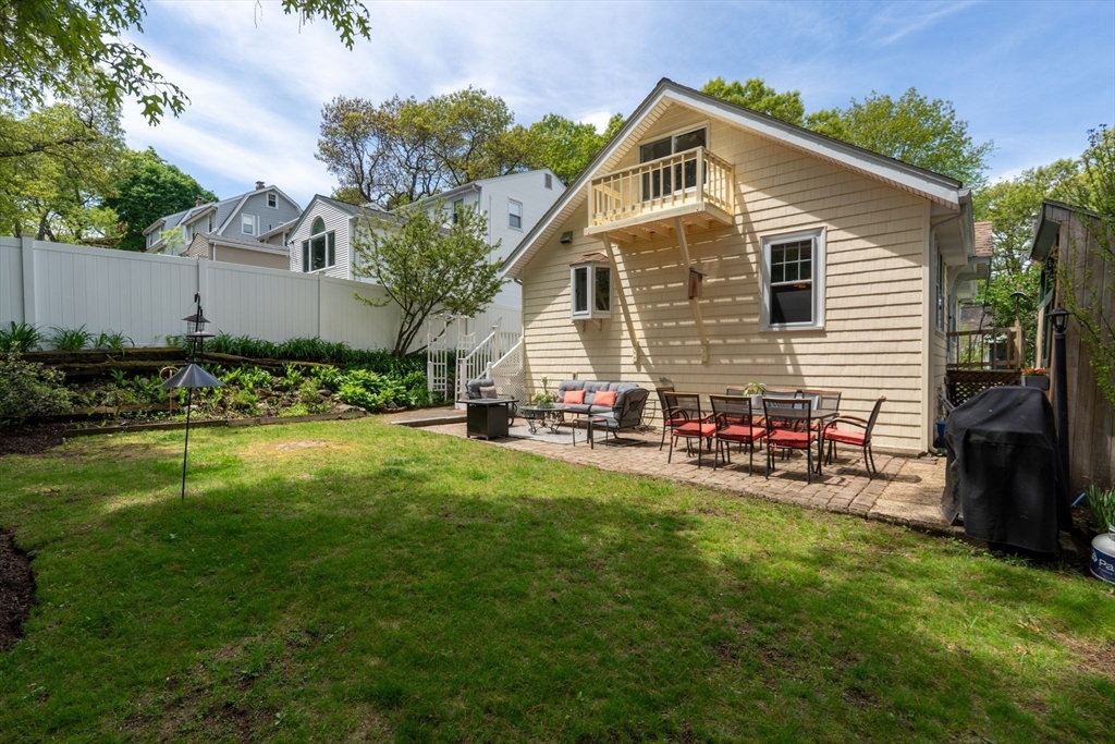 12 Grandview Road Arlington, MA 02476 - Photo 39 of 42 a view of backyard of house with wooden deck and seating