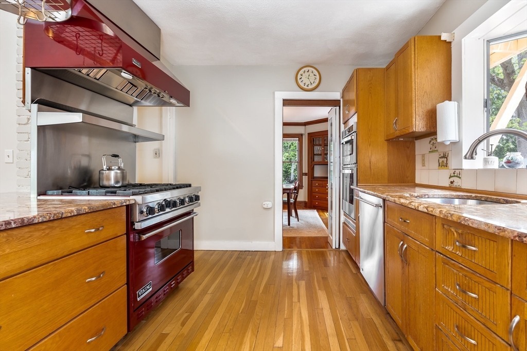 12 Grandview Road Arlington, MA 02476 - Photo 7 of 42 a kitchen with stainless steel appliances granite countertop a stove a sink and a refrigerator