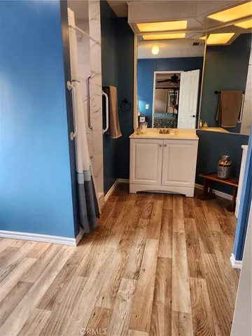 a room with furniture a flat screen tv and a mirror