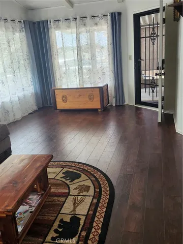 wooden floor with three beds in it