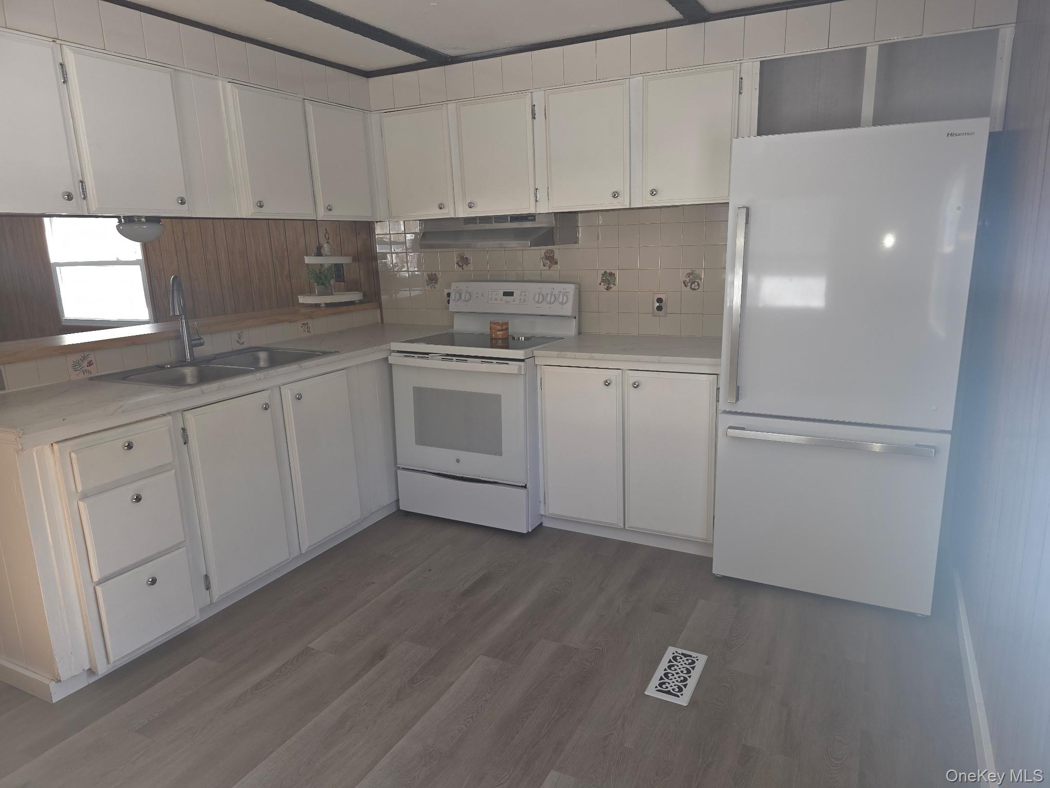 25 Fawn Road, Unit LOT 1 Saugerties, NY 12477 - Photo 5 of 23 a kitchen with white cabinets and white appliances