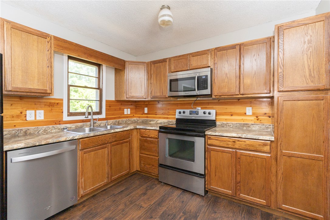 820 Travis Road Anderson, SC 29626 - Photo 17 of 46 This cozy kitchen features abundant wood cabinetry and modern stainless steel appliances.