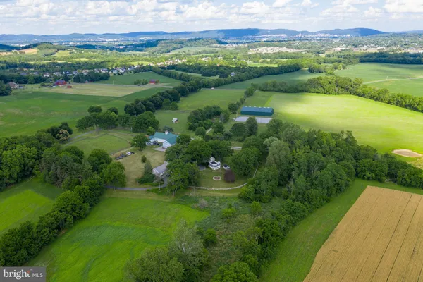 a view of a green field with an ocean