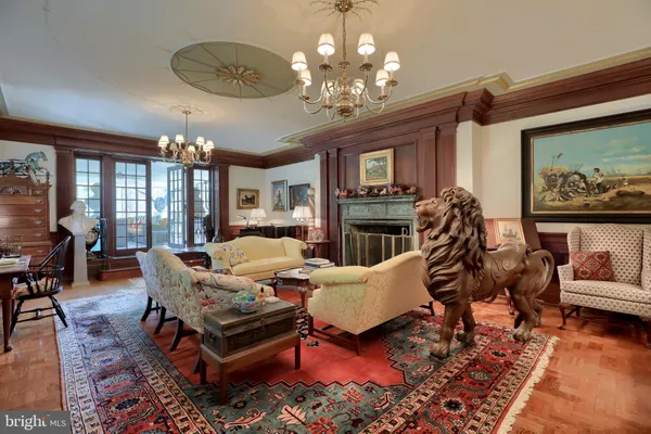 a view of a dining room with furniture wooden floor and a chandelier