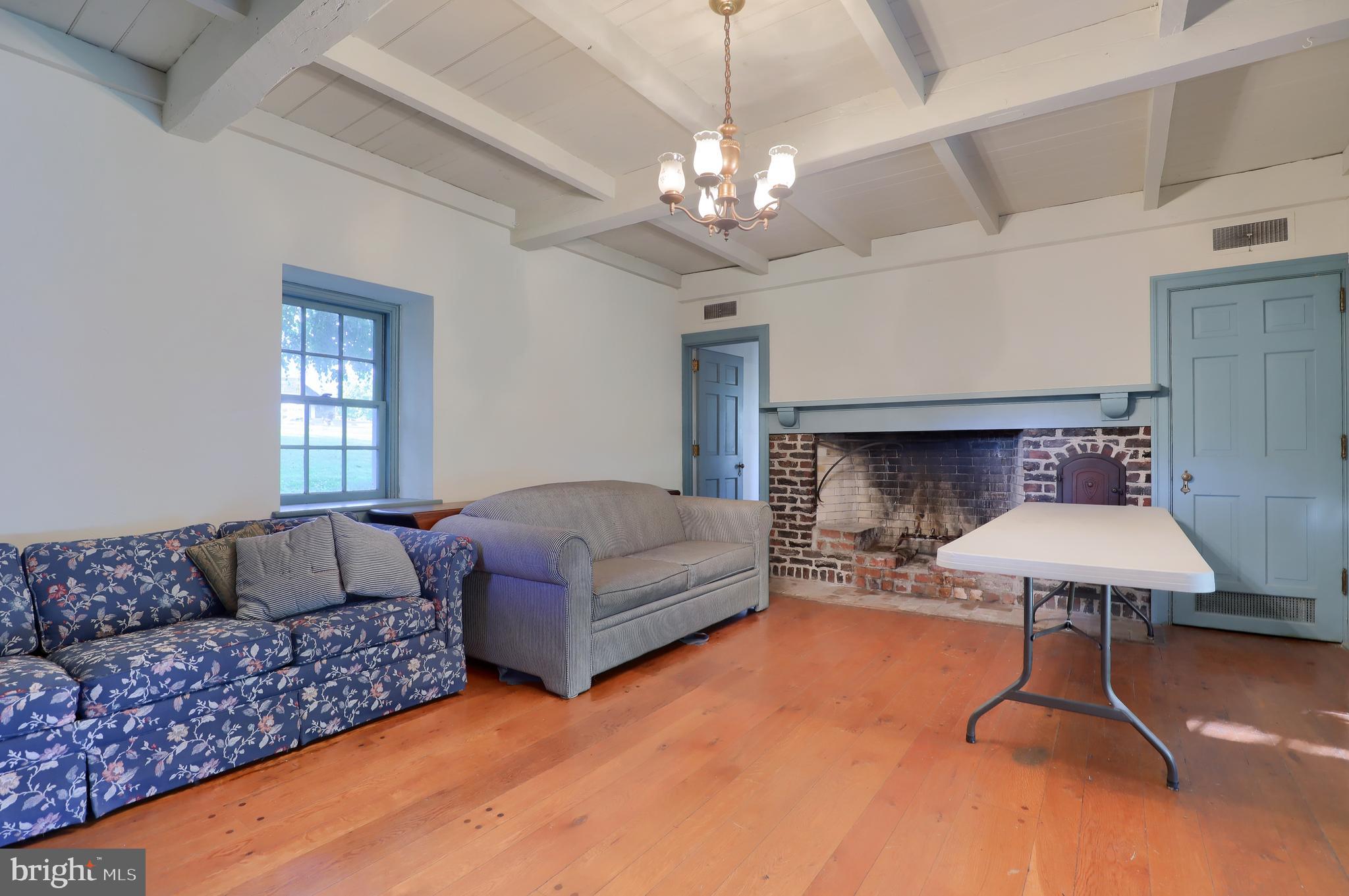 140 Evans Hill Road Reading, PA 19608 - Photo 45 of 70 a living room with furniture a chandelier and a fireplace