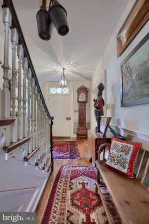 a living room with furniture a chandelier and a rug