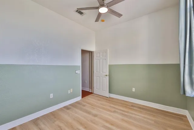 an empty room with windows and closet