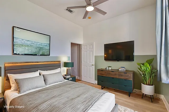 a bedroom with a bed and a flat screen tv