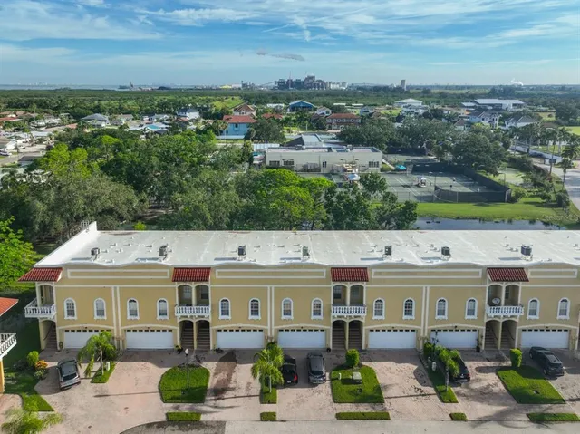 an aerial view of residential houses with outdoor space
