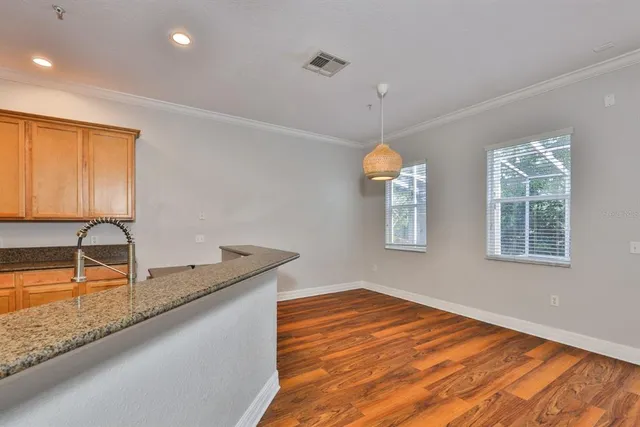 a kitchen with stainless steel appliances granite countertop a sink a granite counter tops and a window
