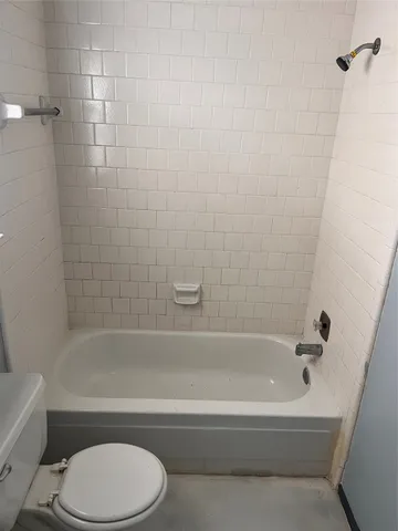 a bathroom with toilet bathtub and shower