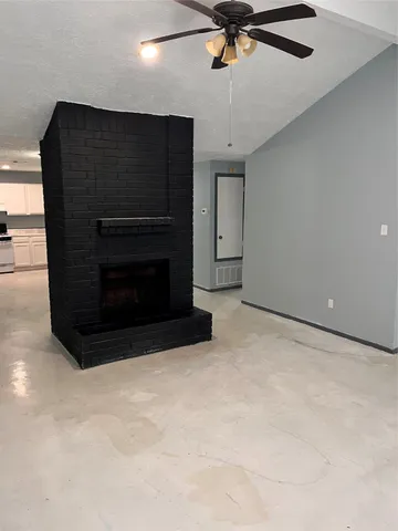 a view of an empty room with a ceiling fan