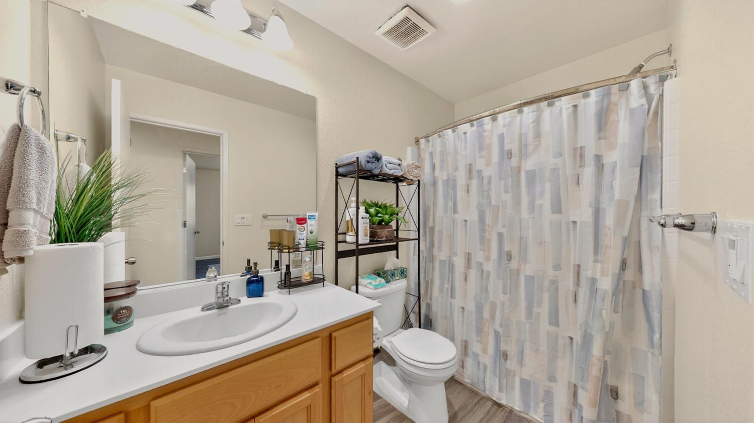 753 Taryn Court Merced, CA 95341 - Photo 12 of 21 a bathroom with a sink toilet and shower
