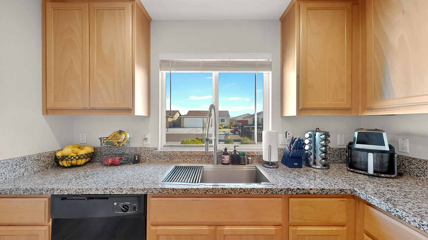 753 Taryn Court Merced, CA 95341 - Photo 6 of 21 a kitchen with granite countertop cabinets and window