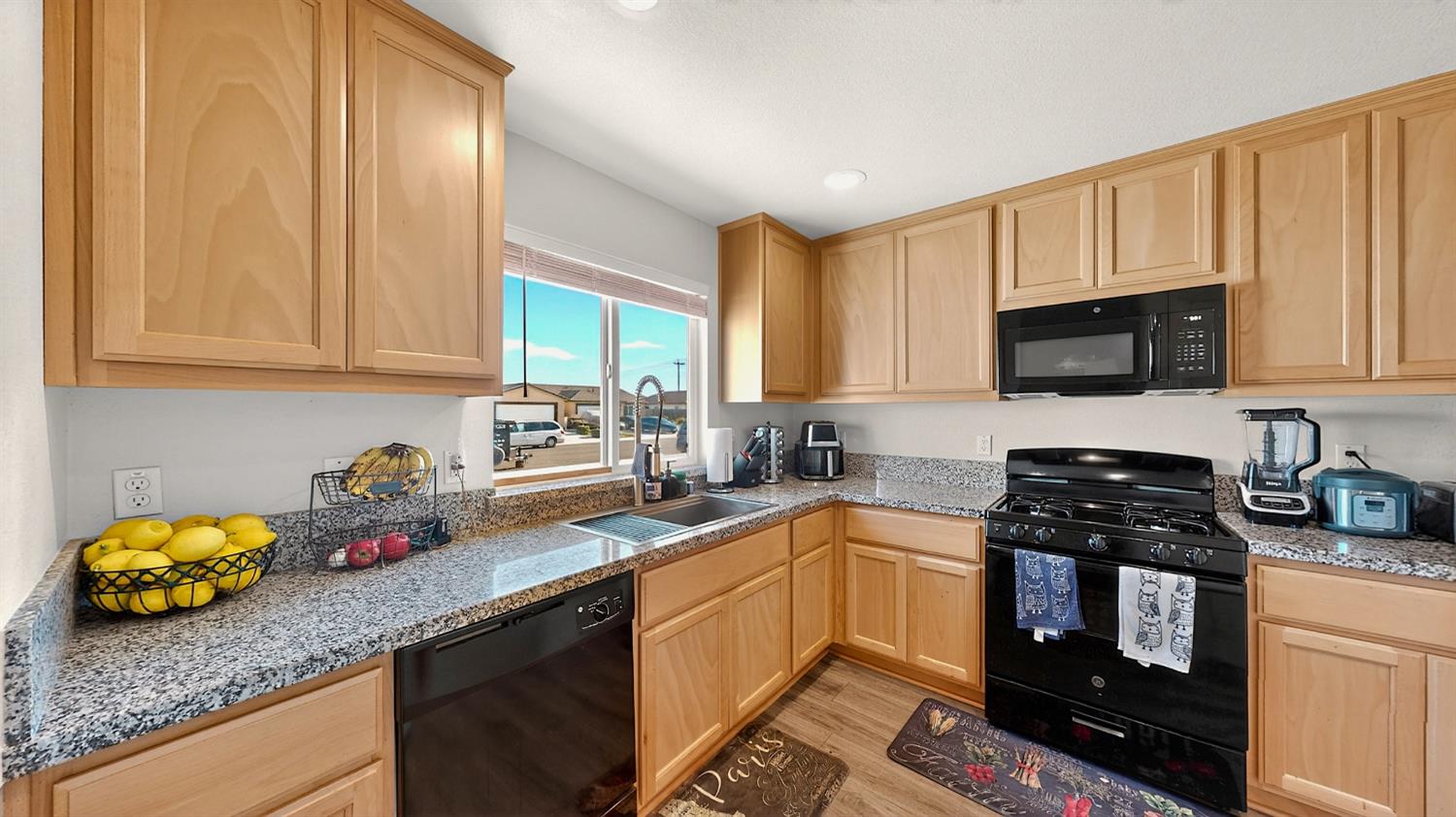 753 Taryn Court Merced, CA 95341 - Photo 7 of 21 a kitchen with stainless steel appliances granite countertop a sink dishwasher stove and oven with cabinets