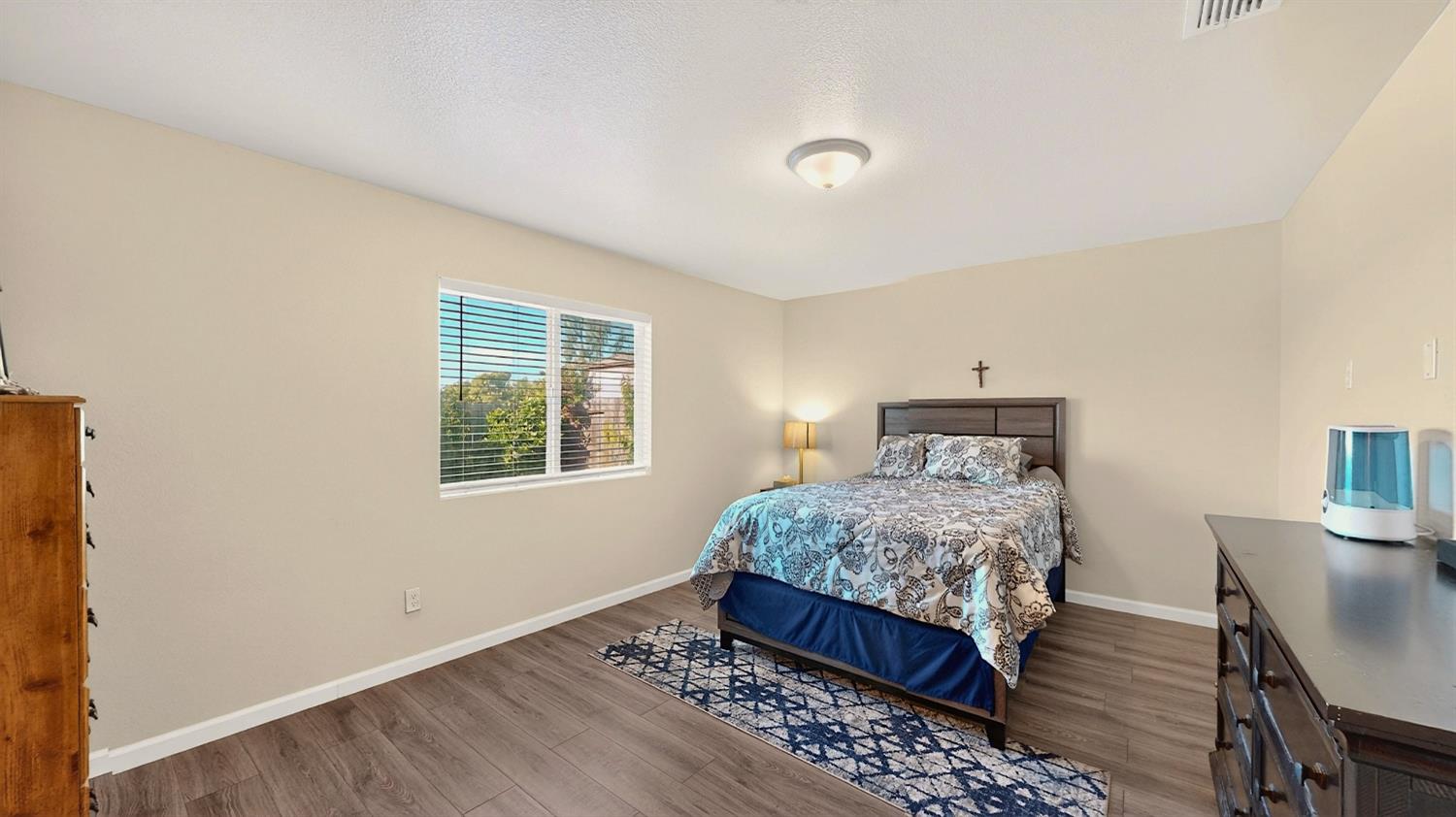753 Taryn Court Merced, CA 95341 - Photo 10 of 21 a bedroom with a bed and wooden floor