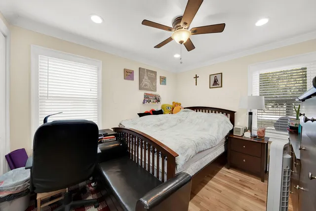 a bedroom with furniture and a large window
