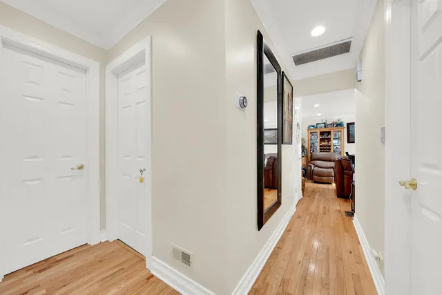 a view of a hallway with wooden floor and bedroom