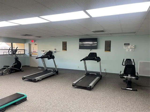 a room with gym equipment and a large window